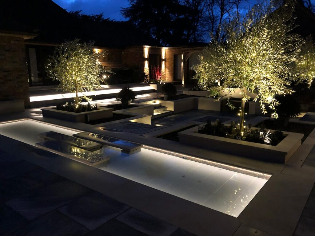 a courtyard with trees and a pool with automated features