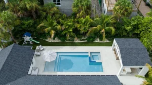 Luxurious sun shelf in a custom Sarasota pool with built-in umbrella holders and ledge loungers