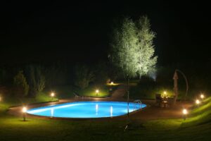 a pool with automated lights at night