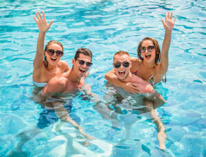 a group of people in a pool enjoying Spotify music