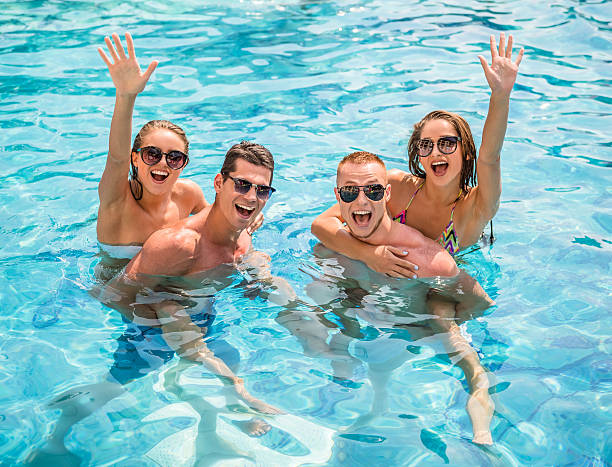 a group of people in a pool enjoying Spotify music
